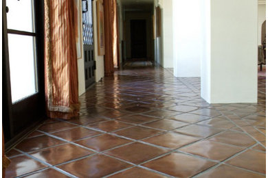 Mid-sized tuscan terra-cotta tile hallway photo in Los Angeles with beige walls