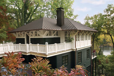 Example of an arts and crafts green three-story exterior home design in Baltimore with a hip roof and a metal roof