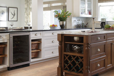Inspiration for a mid-sized rustic l-shaped light wood floor and beige floor enclosed kitchen remodel in Denver with an undermount sink, shaker cabinets, white cabinets, marble countertops, stainless steel appliances and an island