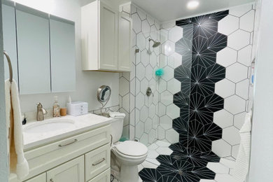 Inspiration for a small modern master black and white tile and ceramic tile ceramic tile, white floor and single-sink bathroom remodel in Dallas with shaker cabinets, white cabinets, a two-piece toilet, white walls, an undermount sink, quartz countertops, white countertops, a niche and a built-in vanity