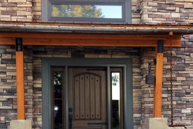 Mid-sized country front door in Other with a single front door and a dark wood front door.