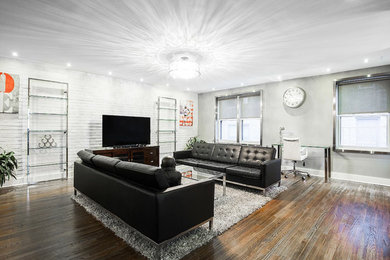 Example of a large transitional open concept dark wood floor and brown floor family room design in Other with gray walls and a tv stand