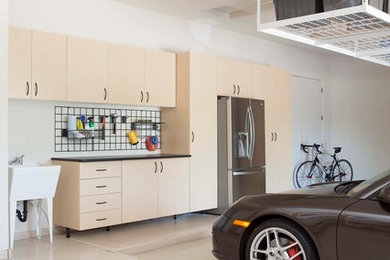 Garage workshop - large contemporary attached garage workshop idea in Omaha