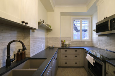 Enclosed kitchen - small traditional galley vinyl floor, gray floor and tray ceiling enclosed kitchen idea in Baltimore with an undermount sink, shaker cabinets, gray cabinets, granite countertops, gray backsplash, porcelain backsplash, stainless steel appliances, no island and black countertops