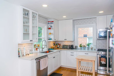 Inspiration for a small l-shaped eat-in kitchen in DC Metro with an undermount sink, shaker cabinets, white cabinets, quartz benchtops, white splashback, subway tile splashback, stainless steel appliances, light hardwood floors and no island.