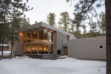 Large minimalist brown two-story wood flat roof photo in Las Vegas