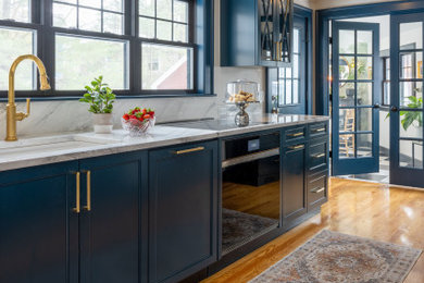 Example of a large transitional galley medium tone wood floor kitchen design in Boston with an undermount sink, shaker cabinets, blue cabinets, quartz countertops, white backsplash, quartz backsplash, paneled appliances and white countertops