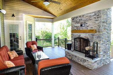 Patio - large craftsman backyard patio idea in Cleveland with a fire pit, decking and a roof extension