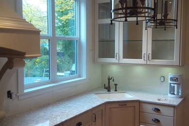 Inspiration for a mid-sized transitional eat-in kitchen remodel in Other with a single-bowl sink, raised-panel cabinets, white cabinets, white backsplash, subway tile backsplash, stainless steel appliances and an island