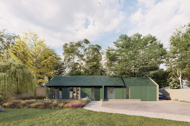 This is an example of a medium sized and green industrial bungalow front detached house in Oxfordshire with wood cladding, a pitched roof, a metal roof and board and batten cladding.