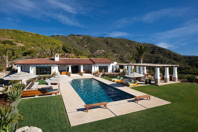 Example of a large tuscan backyard concrete and rectangular pool landscaping design in Santa Barbara
