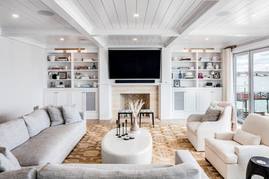 Living room - coastal dark wood floor, brown floor, coffered ceiling and shiplap ceiling living room idea in New York with white walls, a standard fireplace, a stone fireplace and a wall-mounted tv