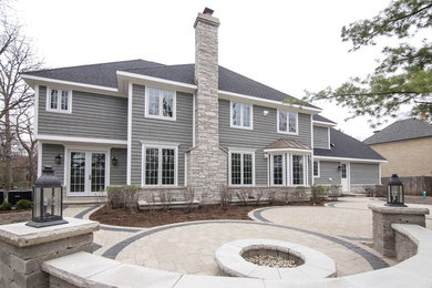 Large elegant backyard brick patio photo in Chicago with a fire pit and no cover