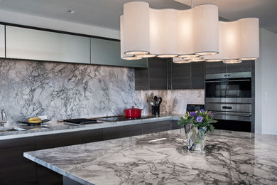 Eat-in kitchen - large transitional single-wall eat-in kitchen idea in St Louis with an undermount sink, flat-panel cabinets, dark wood cabinets, quartz countertops, white backsplash, stainless steel appliances and an island