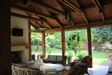 Patio - large craftsman backyard stone patio idea in Birmingham with a fire pit and a roof extension