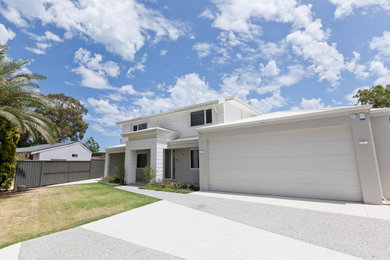 Large contemporary two-storey grey house exterior in Perth with wood siding, a metal roof and a white roof.