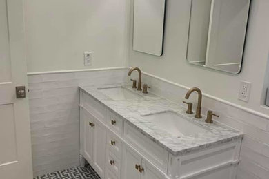 Inspiration for a transitional white tile and subway tile porcelain tile and multicolored floor bathroom remodel in Phoenix with raised-panel cabinets, white cabinets, white walls, an undermount sink, marble countertops and gray countertops