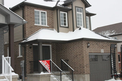 Elegant beige two-story mixed siding exterior home photo in Toronto