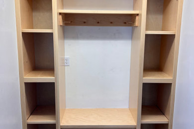 Mudroom - mid-sized traditional mudroom idea with a light wood front door