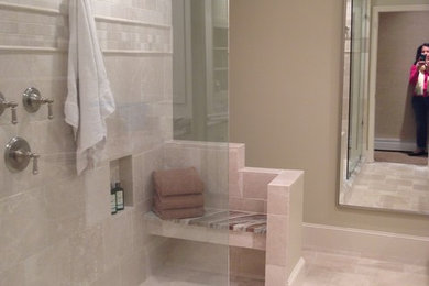 Large elegant master beige tile and stone tile limestone floor doorless shower photo in Other with an integrated sink, white cabinets, granite countertops and beige walls