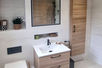 Medium sized bathroom in Surrey with glass-front cabinets, a built-in shower, a wall mounted toilet, brown tiles, wood-effect tiles, beige walls, a pedestal sink, engineered stone worktops, an open shower, white worktops, a single sink, a built in vanity unit and a coffered ceiling.