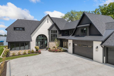Large contemporary multicolored two-story mixed siding house exterior idea in Other with a mixed material roof and a black roof