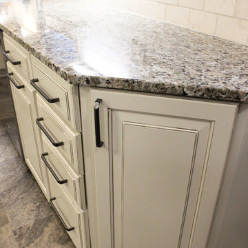 Beige Kitchen with Extra Large Island, Tile Backsplash and Granite Countertops
