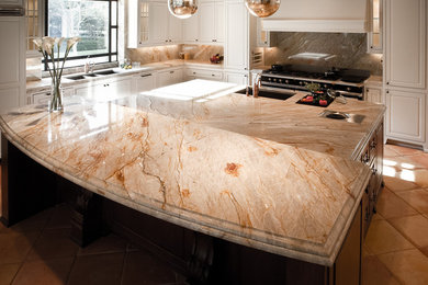 Tuscan kitchen photo in Houston with white cabinets and quartzite countertops