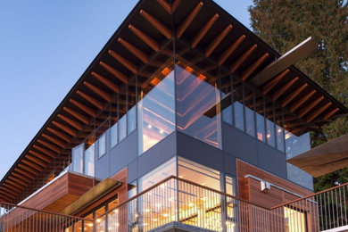 Example of a large minimalist black three-story wood house exterior design in Vancouver