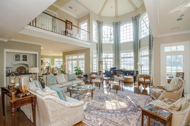 Expansive traditional open concept living room in Atlanta with a music area, beige walls and medium hardwood floors.