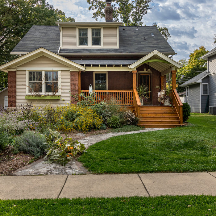Brown one-story mixed siding and board and batten exterior home idea in Chicago with a tile roof and a gray roof