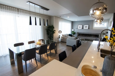 This is an example of a mid-sized contemporary open plan dining in Edmonton with grey walls, light hardwood floors, brown floor and no fireplace.