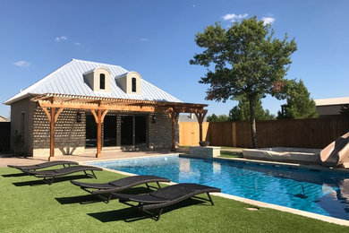 Large trendy backyard rectangular lap water slide photo in Austin
