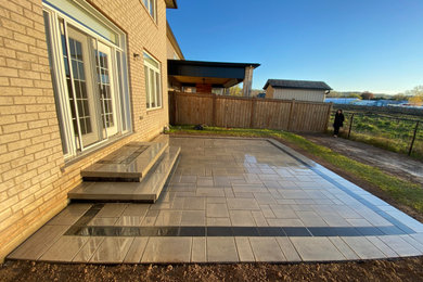 Backyard interlock patio with stone landing (Grimsby)