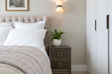 Design ideas for a medium sized contemporary master bedroom in Channel Islands with beige walls, carpet, beige floors and wallpapered walls.