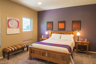This is an example of a large traditional master bedroom in Denver with purple walls and carpet.