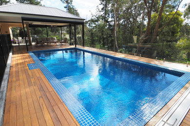 This is an example of a mid-sized modern rectangular pool in Adelaide with decking.
