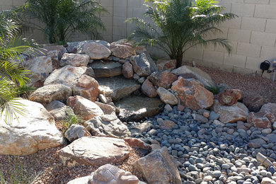 Inspiration for a large traditional partial sun backyard brick water fountain landscape in Phoenix for summer.