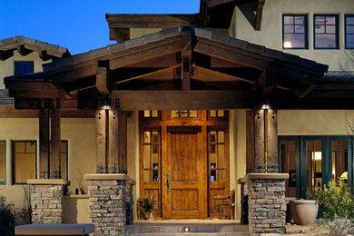 Example of a large arts and crafts beige two-story concrete exterior home design in Phoenix