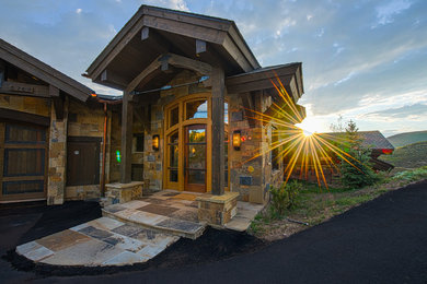 Inspiration for a large rustic entryway remodel in Denver with a glass front door