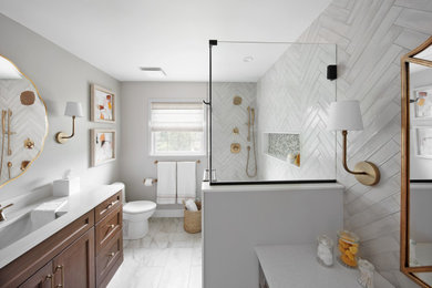 Mid-sized transitional kids' white tile and ceramic tile single-sink, ceramic tile and white floor bathroom photo in Philadelphia with raised-panel cabinets, medium tone wood cabinets, a one-piece toilet, an undermount sink, quartzite countertops, white countertops, a built-in vanity, a hinged shower door, a niche and gray walls
