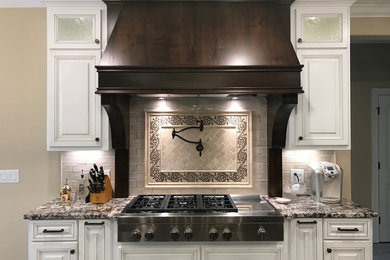 Huge elegant u-shaped eat-in kitchen photo in Nashville with raised-panel cabinets and two islands