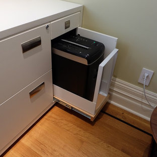 Design ideas for a mid-sized contemporary study room in San Francisco with yellow walls, light hardwood floors and a built-in desk.