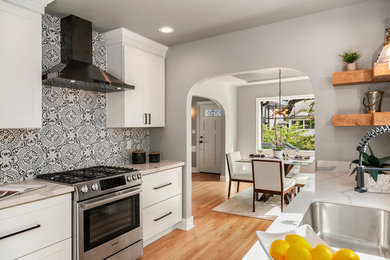 Mid-sized arts and crafts medium tone wood floor and brown floor kitchen photo in Seattle with an undermount sink, shaker cabinets, white cabinets, quartzite countertops, white backsplash, ceramic backsplash, stainless steel appliances, no island and white countertops