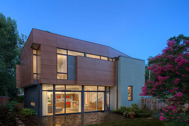 Example of a large trendy two-story exterior home design in Other