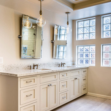 Grey/tan bathroom vanity with her and hers sinks, built-in counter with dresser