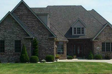 Large transitional gray two-story stone exterior home idea in Indianapolis