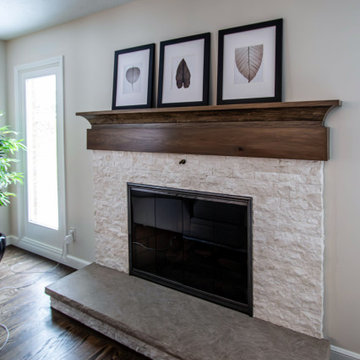Two Tone Kitchen with Floating Shelves and Island Seating and Updated Fireplace