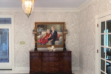 Example of a large classic marble floor and white floor entryway design in New York with white walls and a white front door