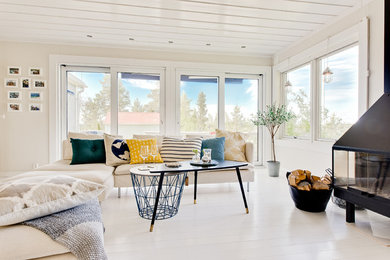 Mid-sized danish formal and open concept painted wood floor and white floor living room photo in Charleston with beige walls, a wood stove, a metal fireplace and no tv